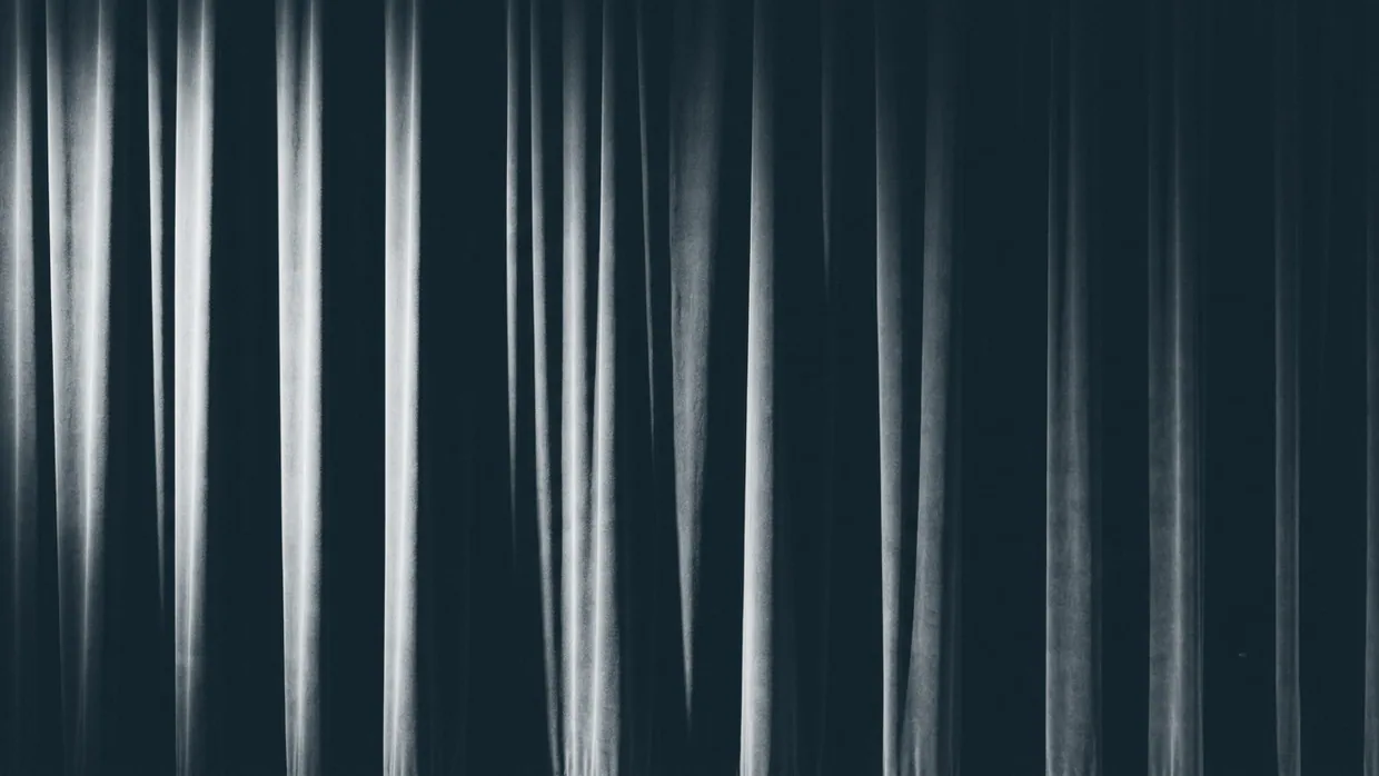 Abstract study of heavy dark fabric in deep folds